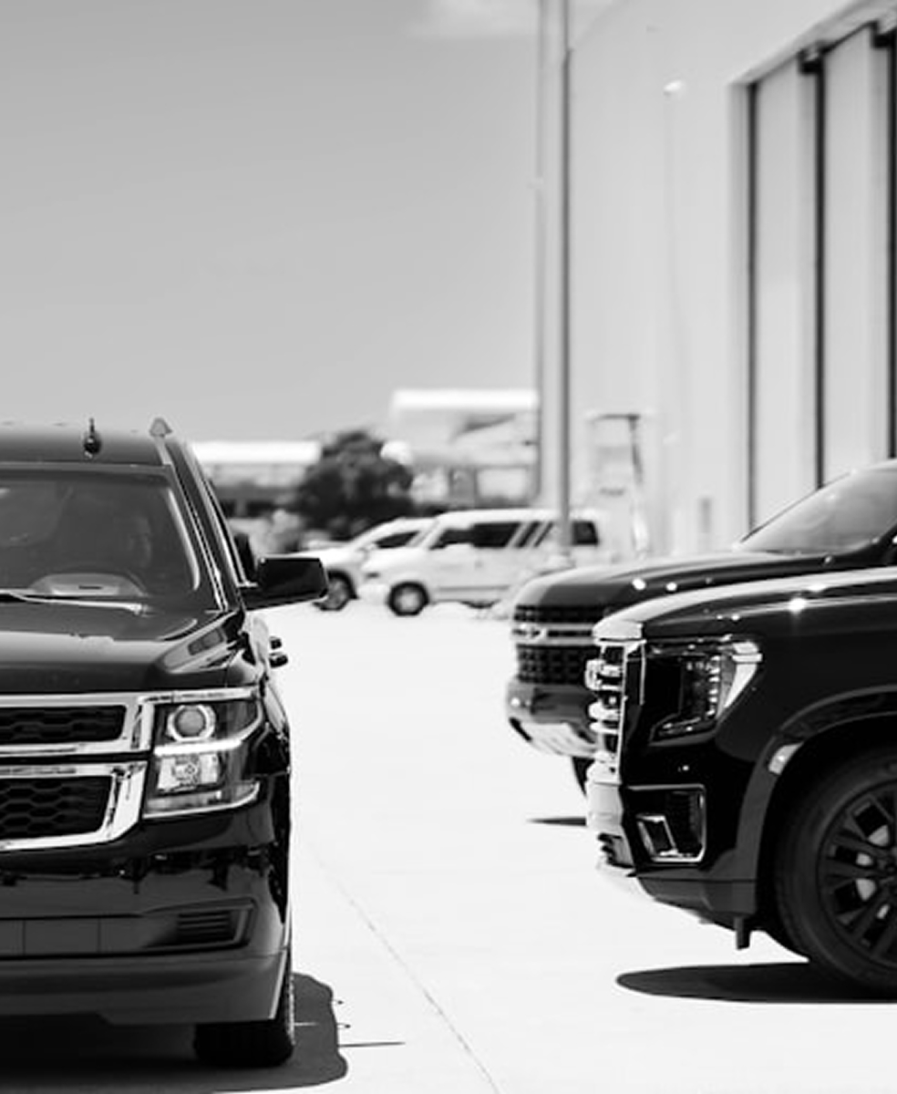 Fancy cars parked in front of a building somewhere. They are Chevrolet, for whatever that's worth.