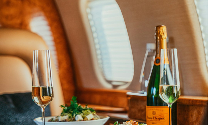Champagne and a fancy meal on a private airplane